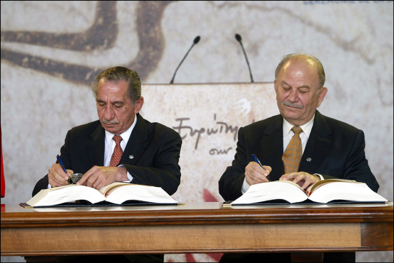 Assinatura do tratado de adesão à UE, por Tassos Papadopoulos, presidente (esquerda) e George Iacovou (ministro dos Negócios Estrangeiros)