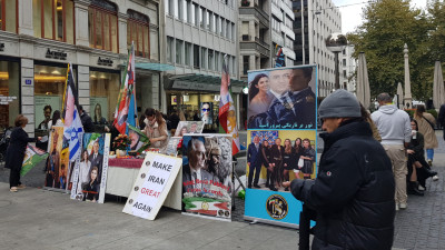 Grupo de iranianos pró-Pahlavi manifesta-se em Genebra com bandeiras de Israel e cartazes onde se lê “Make Iran Great Again”.