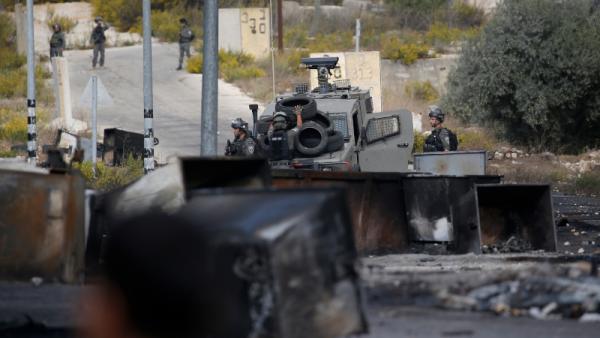 Soldados israelitas vigiam durante confrontos com manifestantes palestinianos na entrada norte da cidade de Ramallah