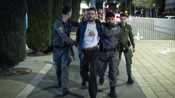 Agentes da polícia detêm um manifestante numa manifestação contra a guerra de Israel com o Irão, na Praça Habima, em Telavive, a 28 de março de 2026.